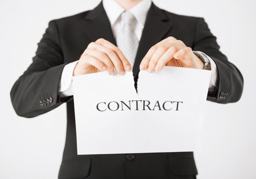 - Attorneys.Media - Legal Expert Interviews & Trusted Advice Man in a Suit Tearing a Contract Document in Half.