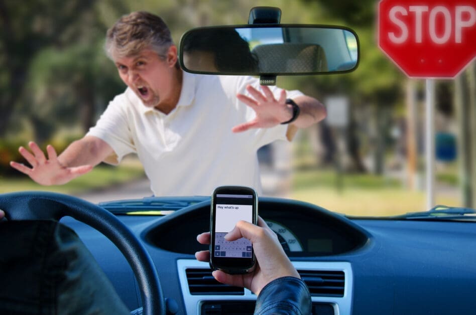 - Attorneys.Media - Legal Expert Interviews & Trusted Advice Driver’s View: a Man in White Shirt Lunges Toward the Car with Hands Raised, As a Passenger Texts on a Phone in the Foreground Near a Stop Sign Outside the Windshield.