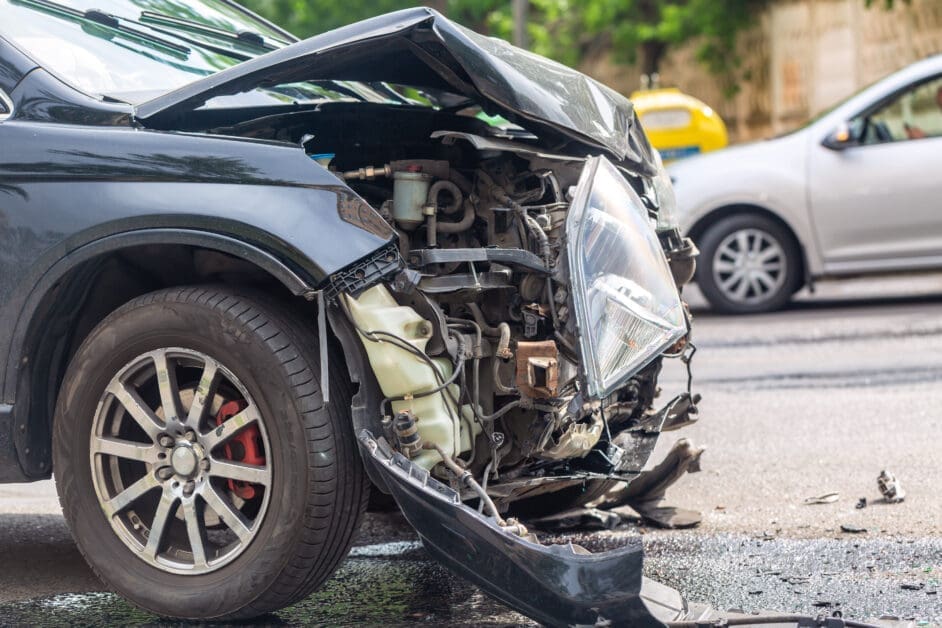 Front-end Collision Showing a Dark Suv with a Crumpled Hood and Exposed Engine Components, Debris on the Road