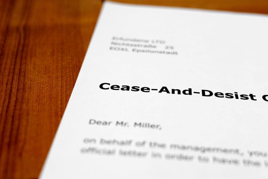 Close-up of a Cease-and-desist Letter on a Wooden Desk at an Angle.
