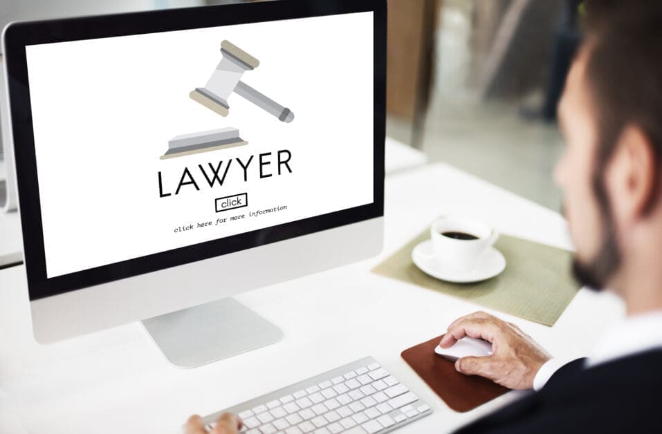 Computer screen shows a lawyer branding with a gavel icon and the word LAWYER, plus a small 'click' box and 'click here for more information' text (informational image).