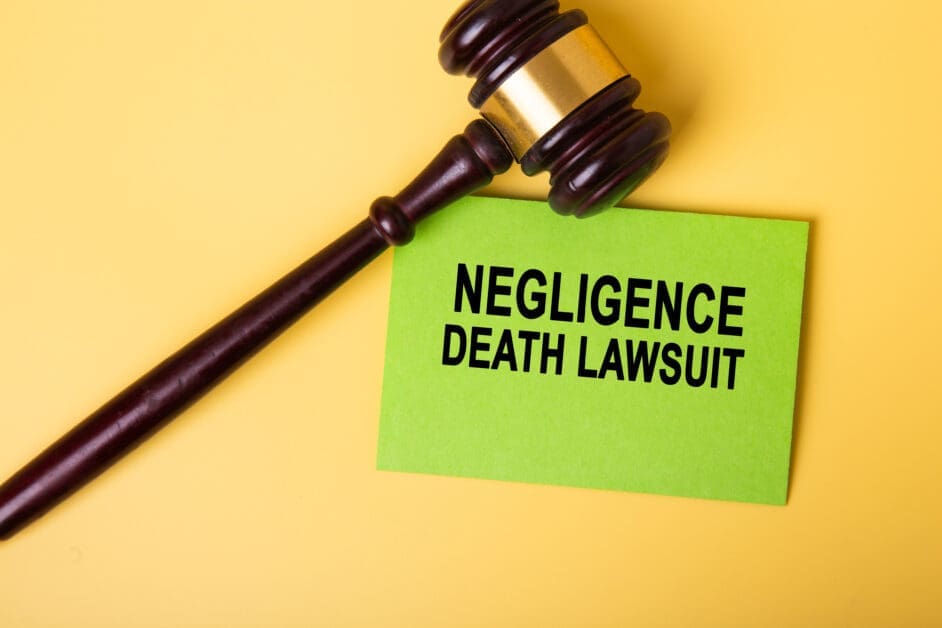 - Attorneys.Media - Legal Expert Interviews & Trusted Advice Gavel Lying on a Lime Sticky Note That Reads 'negligence Death Lawsuit' on a Yellow Background, Indicating a Legal Case Setup.